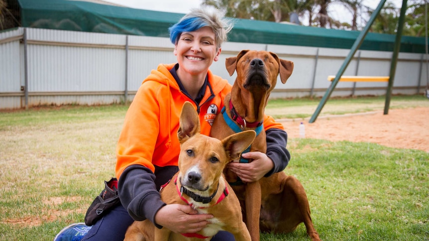 Dog trainer Leah and blind dog Samson and his helper, Ayah.