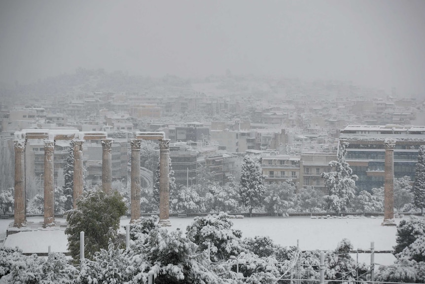 Snow covers the ancient temple of Zeus in Athens.