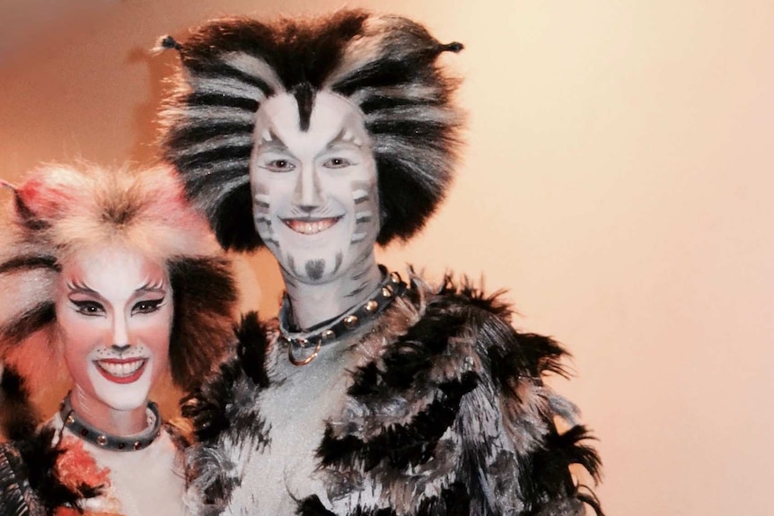 a man and a woman in Cats costume and makeup