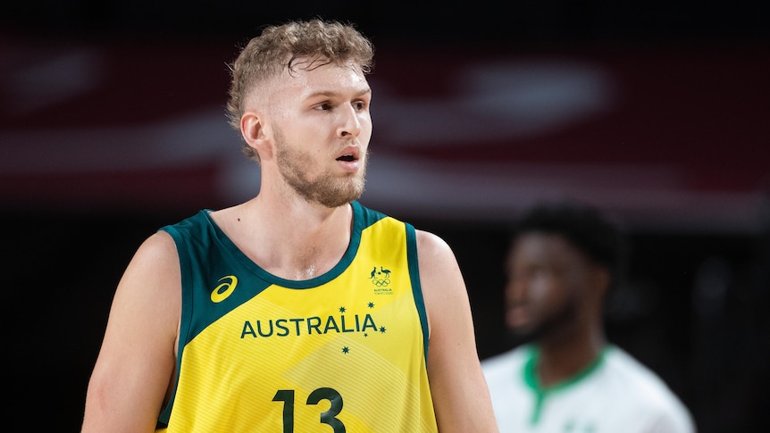 Jock Landale of Australia looks into the distance while wearing his Australian number 13 basketball top