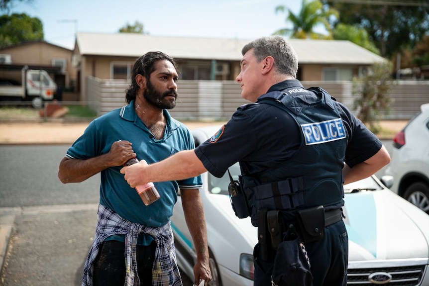 A man argues with a police officer