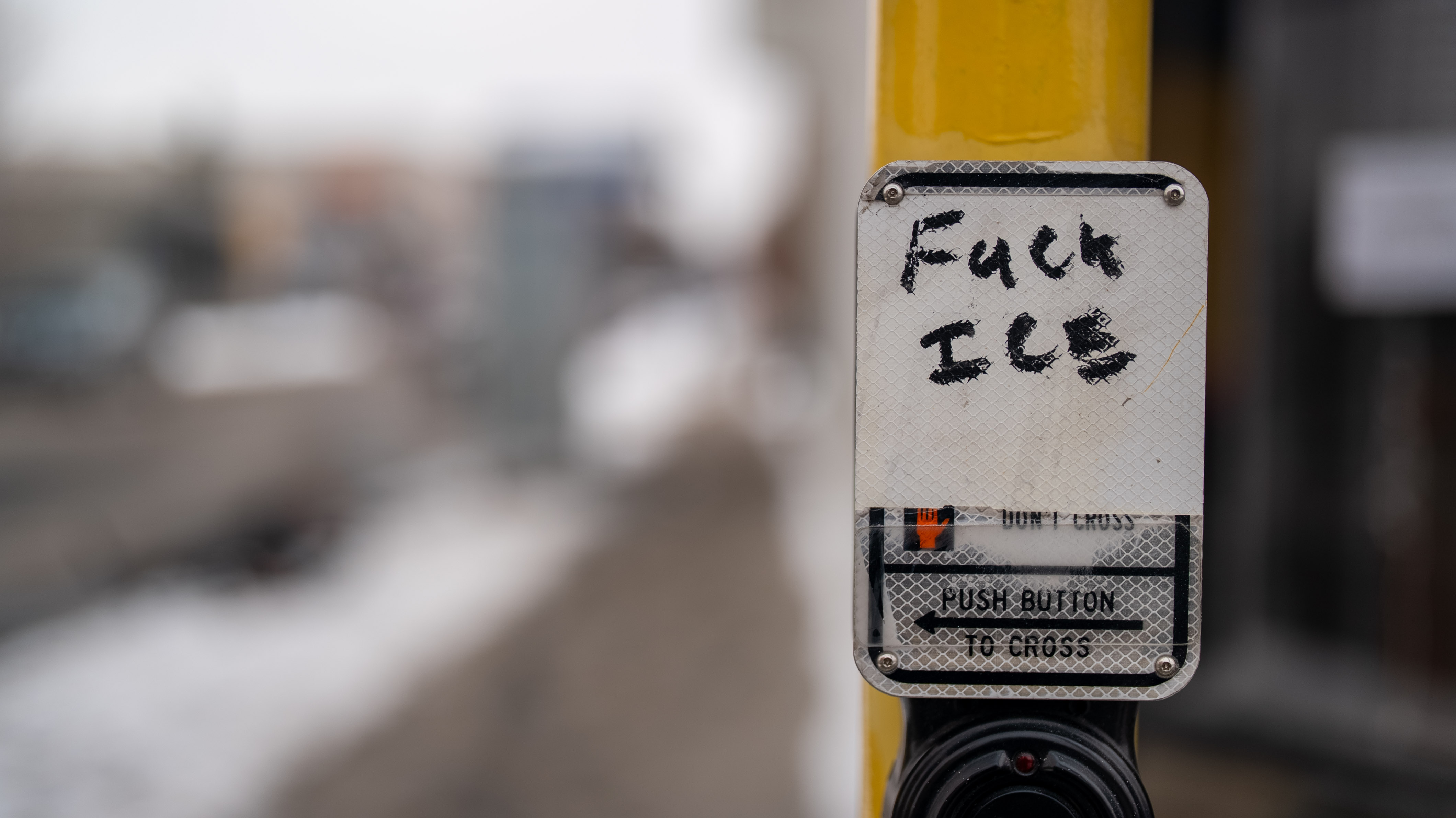 A traffic sign that's been graffitied over with the words "f*** ice".