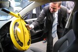 Tasmanian premier David Bartlett inspects a wheel steering clamp.