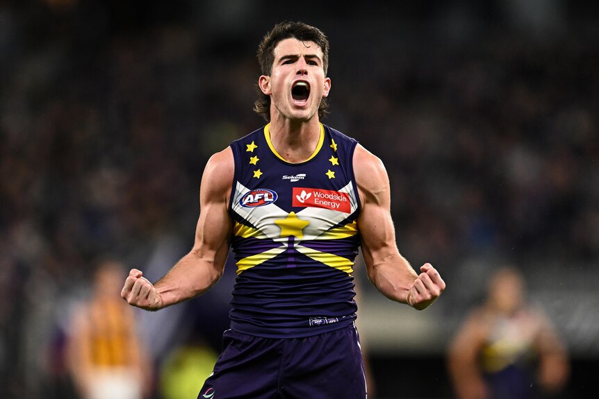 Andrew Brayshaw clenches his fists and yells in celebration