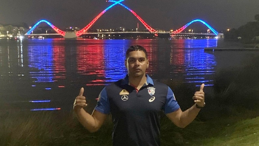 Brennan Stack pictured in front of a bridge lit up at night