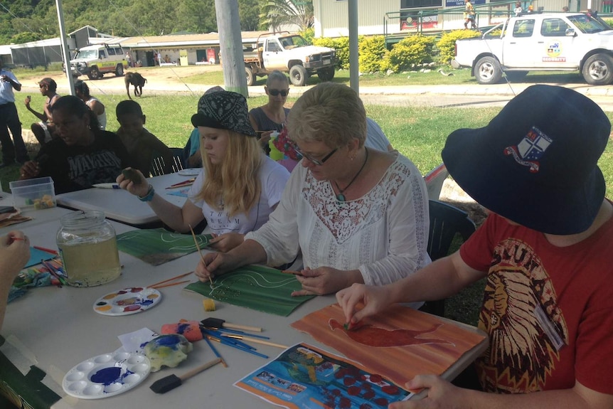 Tourists on Palm Island learning dot painting