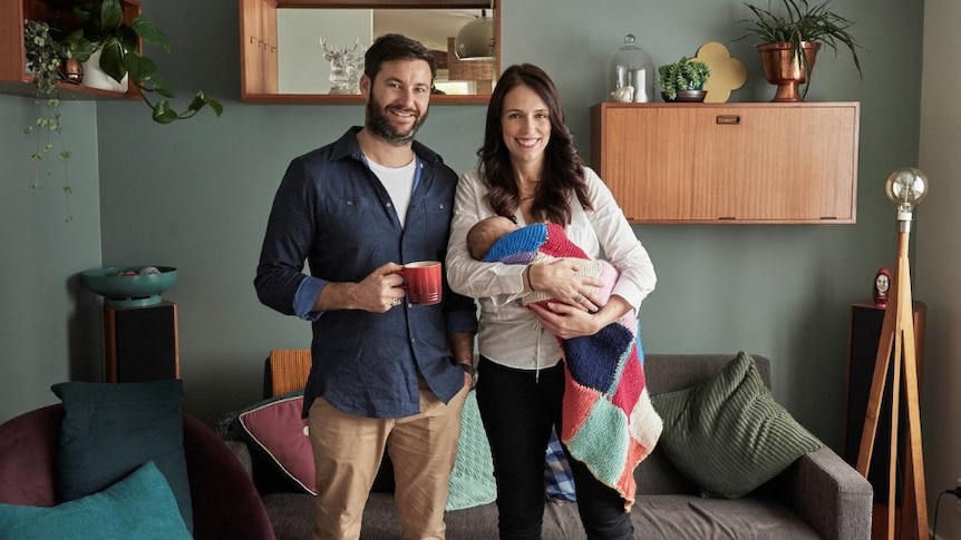 Jacinda Ardern carrying her newborn baby with partner Clarke Gayford.