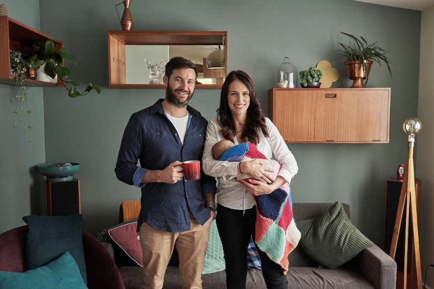 Jacinda Ardern carrying her newborn baby with partner Clarke Gayford.