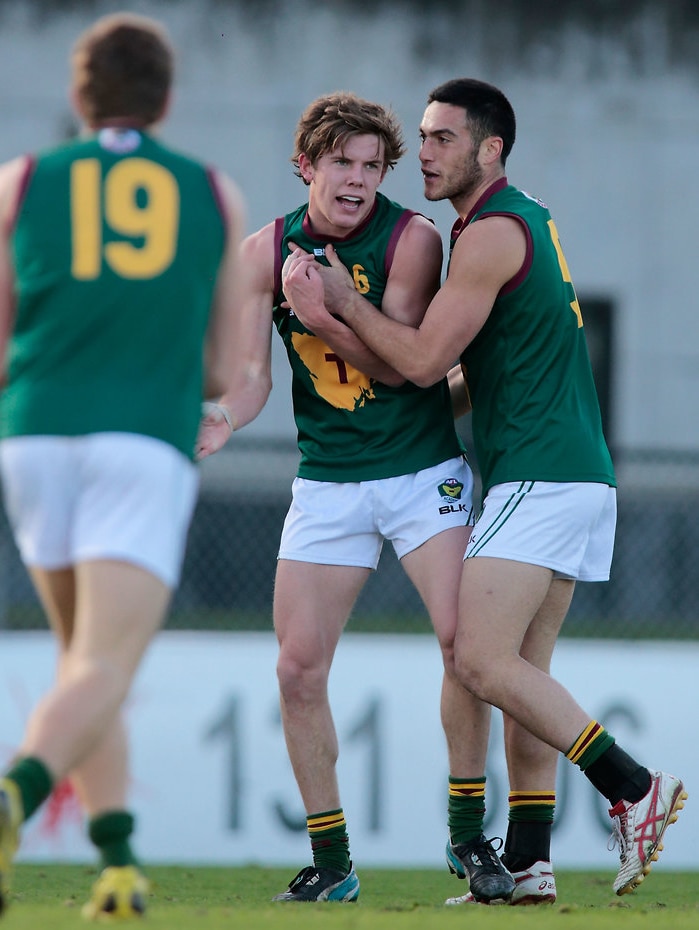 Australian football players on a field.