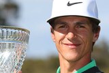 Danish golfer Thorbjorn Olesen poses with the trophy after winning the 2014 Perth International.