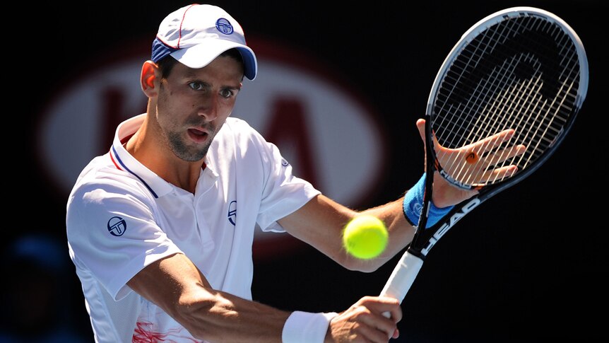 Novak Djokovic plays a backhand