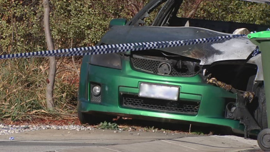 car with burnt bonnet and police tape across the front