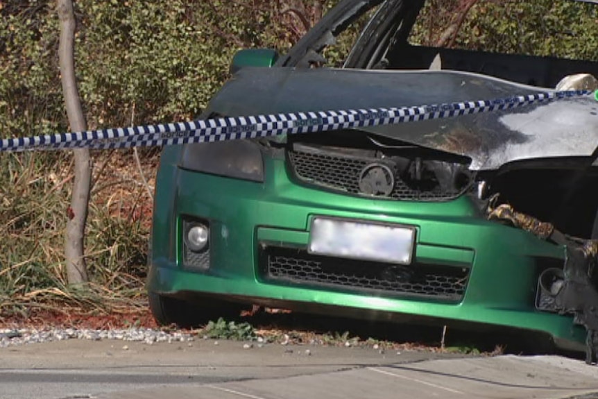 Car with burnt bonnet and police tape across the front.