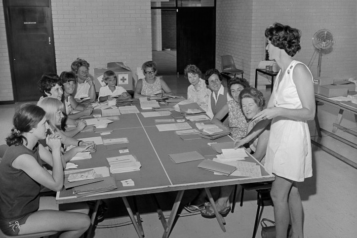 Members of the Red Cross assembling packs of information for migrants at Noalimba, February 1970