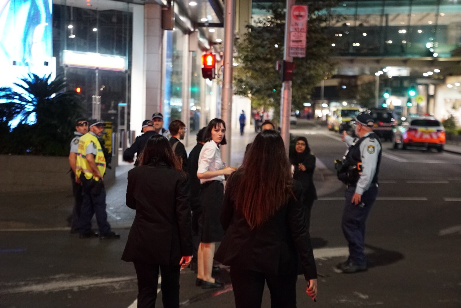 People stand on the street at Bondi Junction westfield after the stabbing incident on saturday april 13 2024