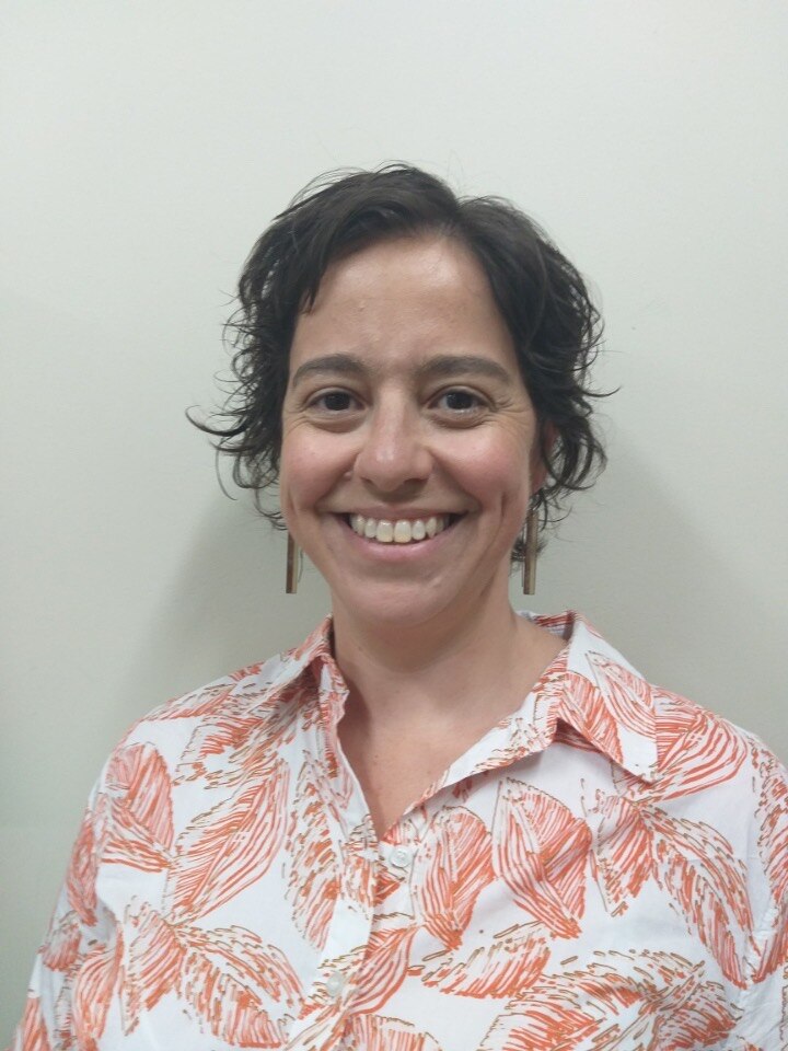 A head and shoulders profile photograph of Dr Alyssa Vass, she's smiling and has short dark hair.