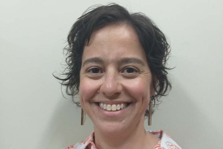 A head and shoulders profile photograph of Dr Alyssa Vass, she's smiling and has short dark hair.