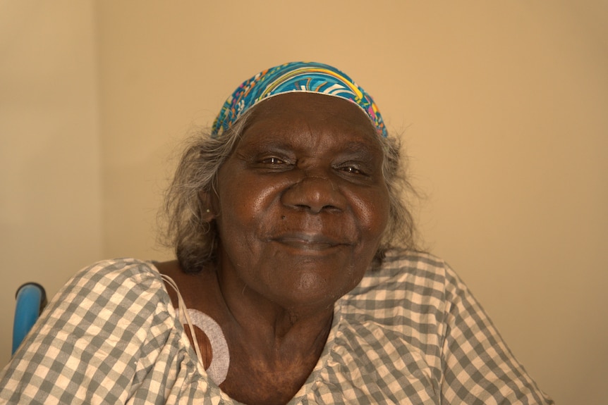 An Aboriginal woman smiles at the camera.