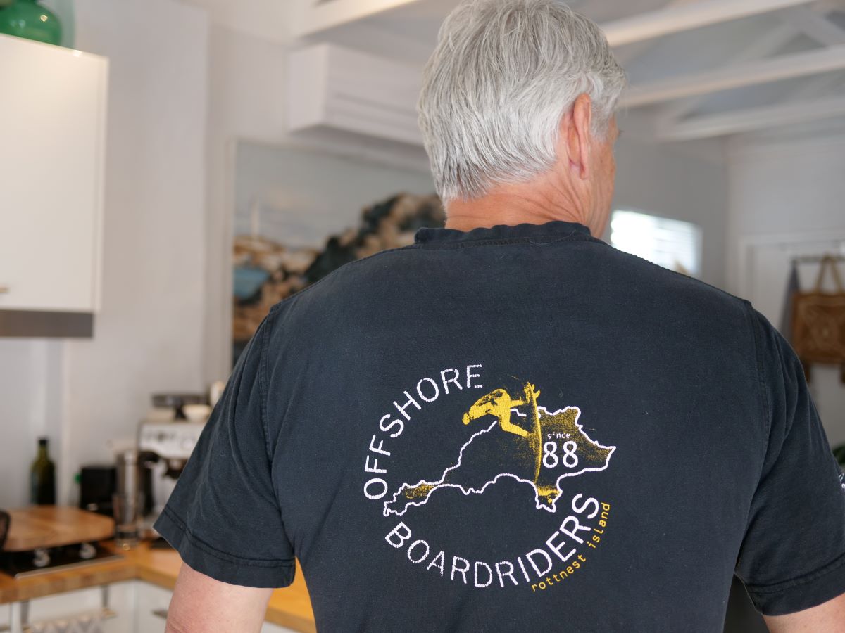 Keiran faces away from the camera with his black t-shirt in focus, with a logo reading "offshore boardriders 88".