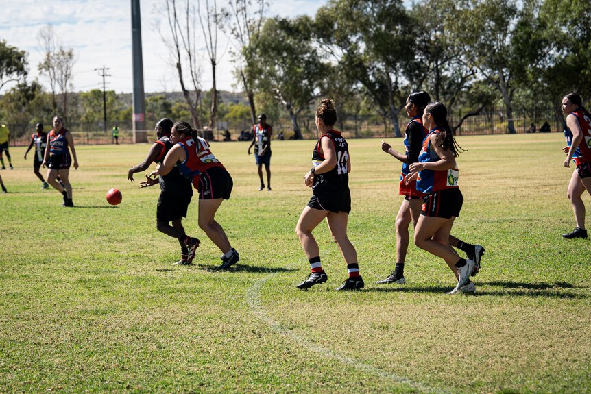 A photo showing Epenarra Saints women's players marking each other during an AFL game.