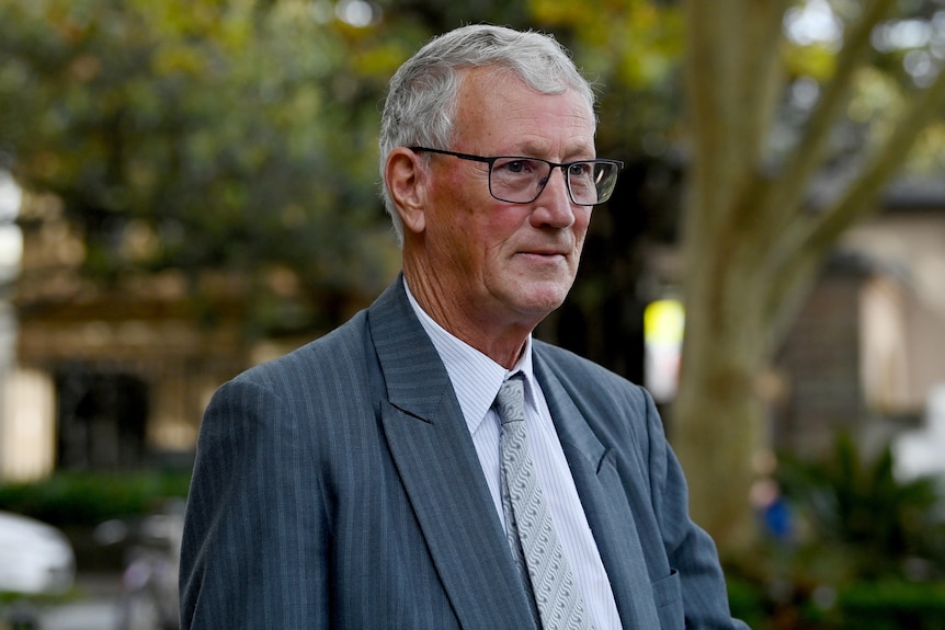 A man in a suit looking to the side