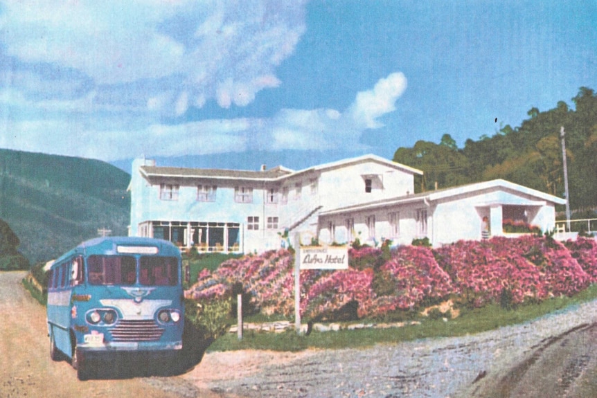 Colour photo from a newspaper of the Lufra Hotel with a bus outside