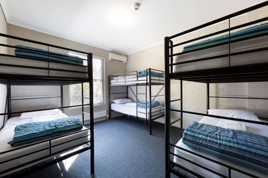 Several bunk beds in a bare room.
