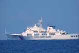 A Chinese coast guard ship is seen in the distance in the South China Sea.  