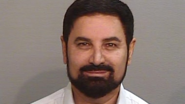 a man with a beard and  moustache looking at the camera