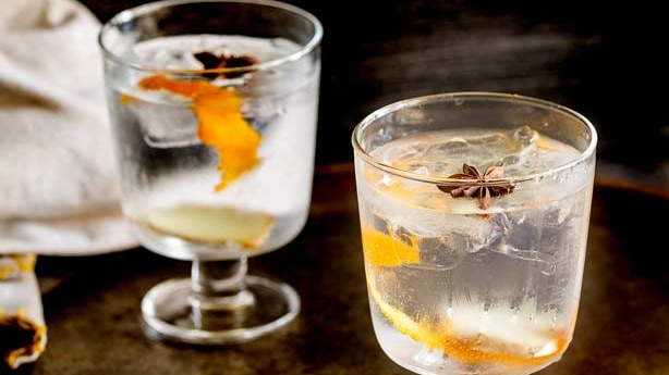 Two classes on a table containing gin and tonic