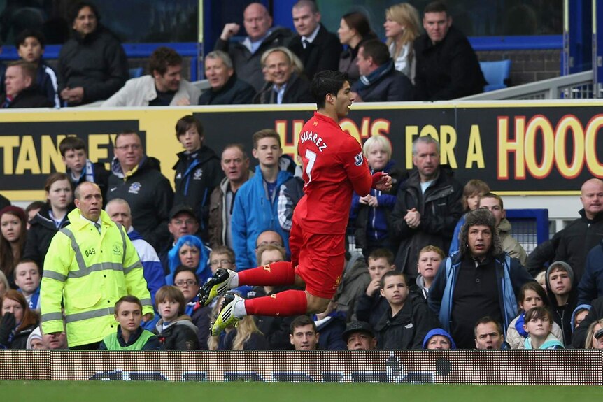 Making a splash: Suarez celebrated his first goal with a theatrical dive in front of the Everton bench.