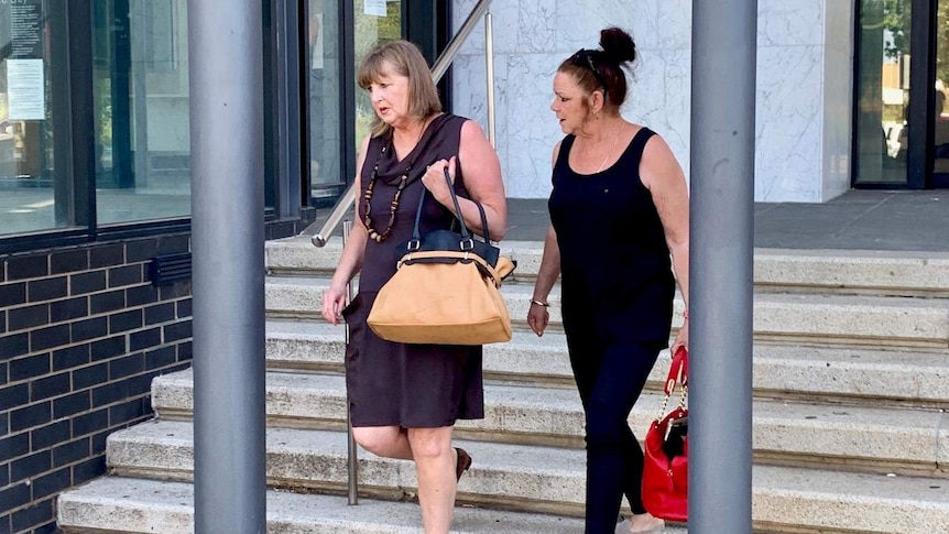 Two women walk down the stairs of the Ballarat Courthouse