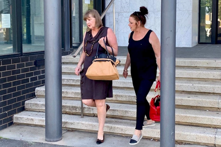 Two women walk down the stairs of the Ballarat Courthouse