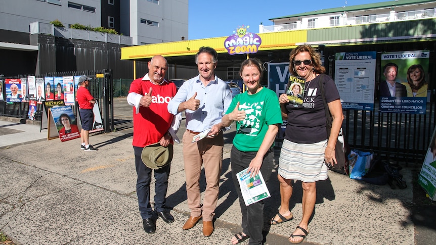 Four standing at a polling booth in Wollongong.