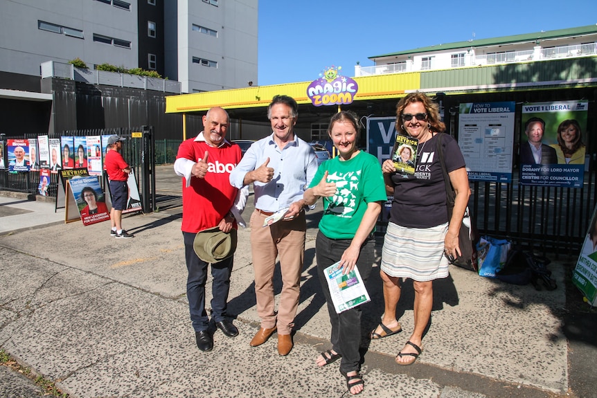 Four standing at a polling booth in Wollongong.