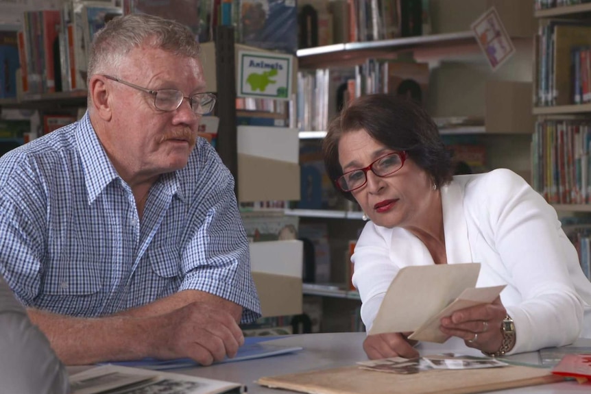 Wayne Bailey and Sandra Goodwin looking at old photos