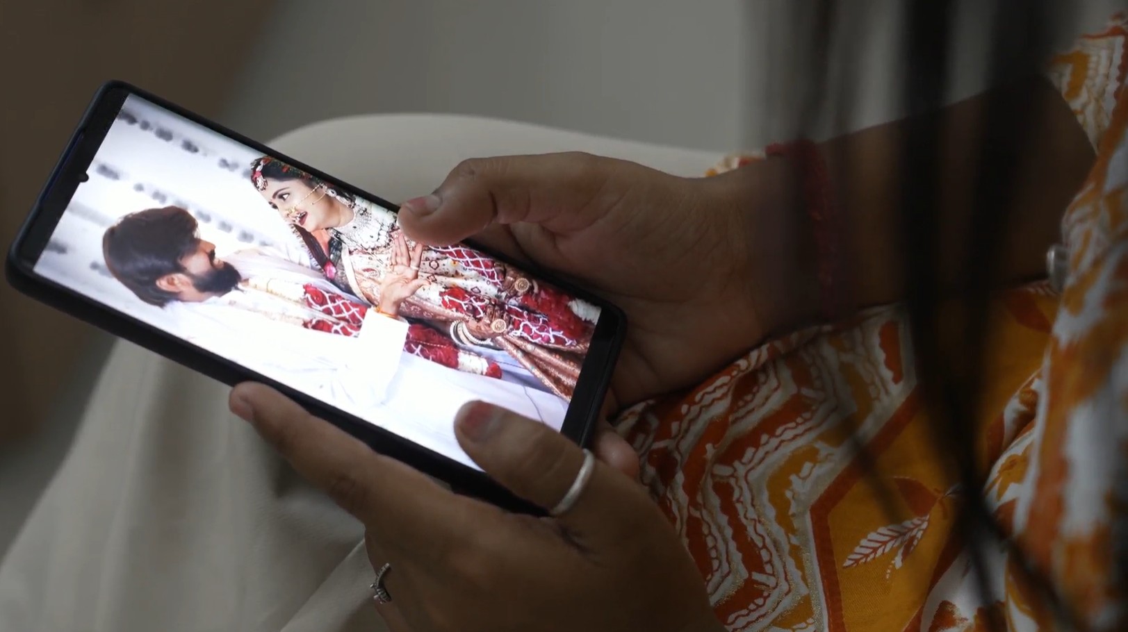 Wedding couple image on the phone screen.