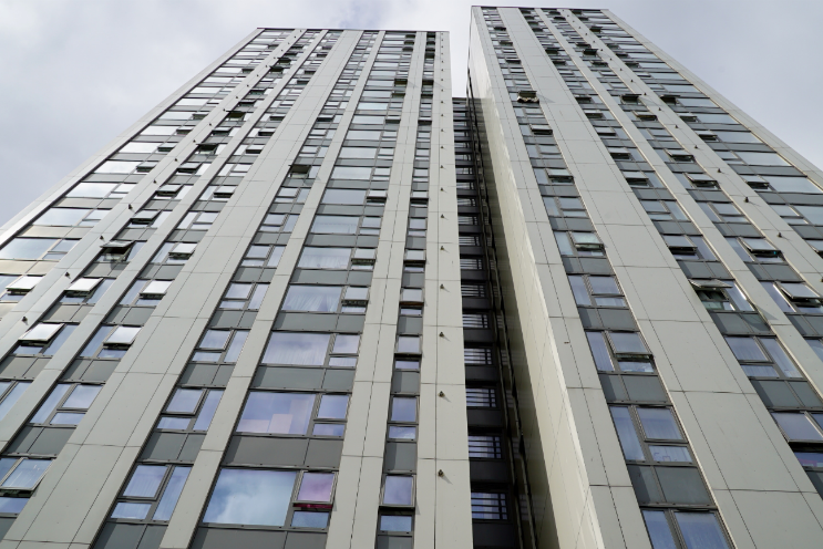 A London housing tower taken from the base of the building, panning upwards.