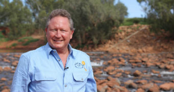 Man wearing blue button up shirt poses for camera in rural Australia.