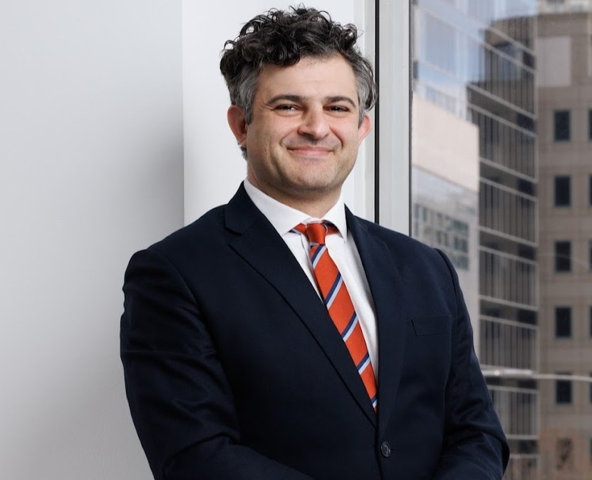 A professional headshot of Yianni kordos wearing a suit.