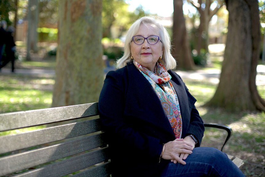 Anne Hollonds sits in a park