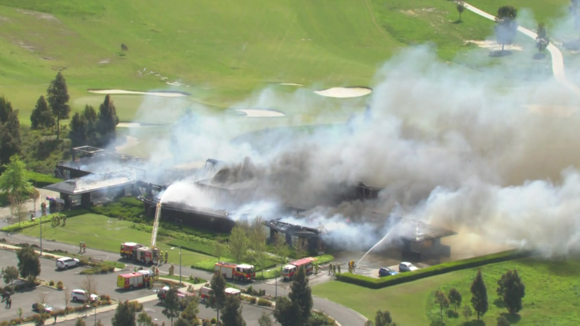 A building on fire at a golf course