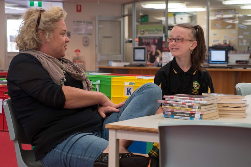 Susannah McFarlane chats with Emma Craig in the Munno Para Primary School library.