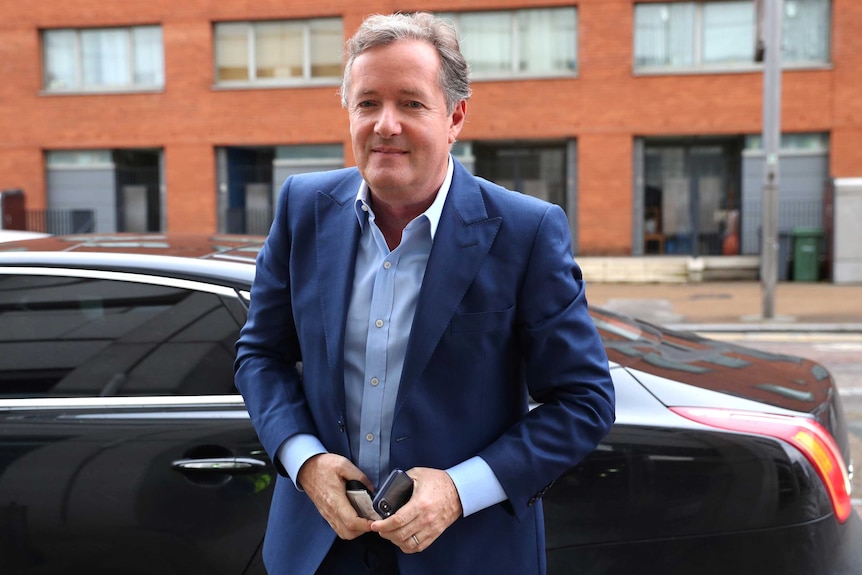 Piers Morgan getting out of a car.