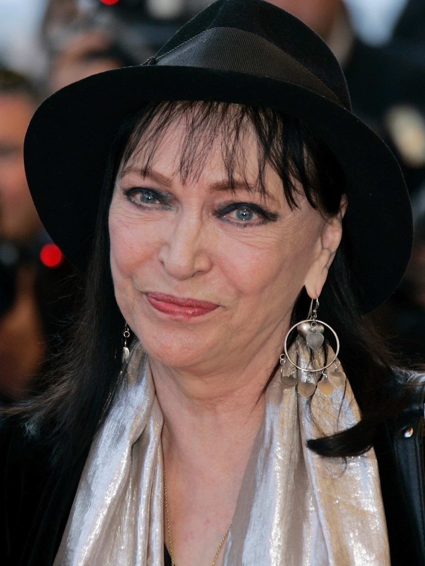 Anna Karina wearing a black hat on the red carpet of Cannes Film Festival