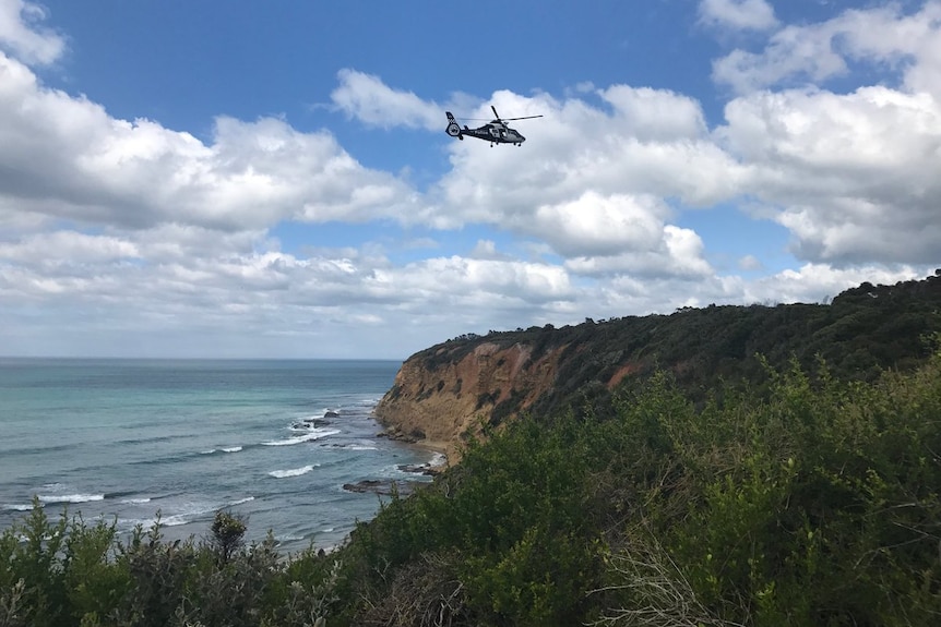 A helicopter searches for missing woman Elisa Curry at Aireys Inlet on the Surf Coast.