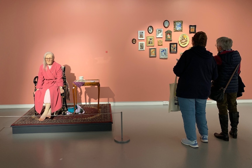 women staring at Gallery images and sculptures