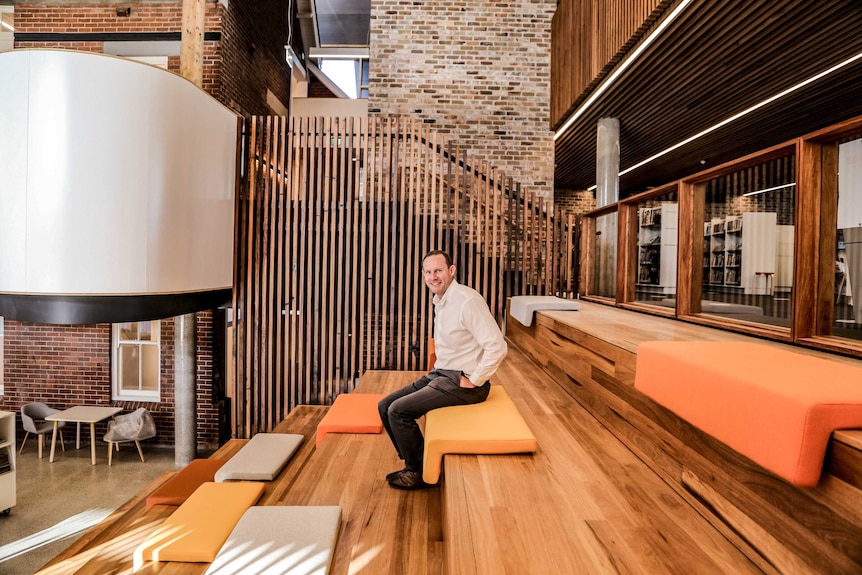 Inner West Mayor Darcy Byrne sitting on stars in the new Marrickville library.