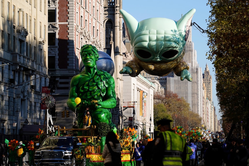 The Green Giant float and Baby Yoda balloon make their way down Central Park West