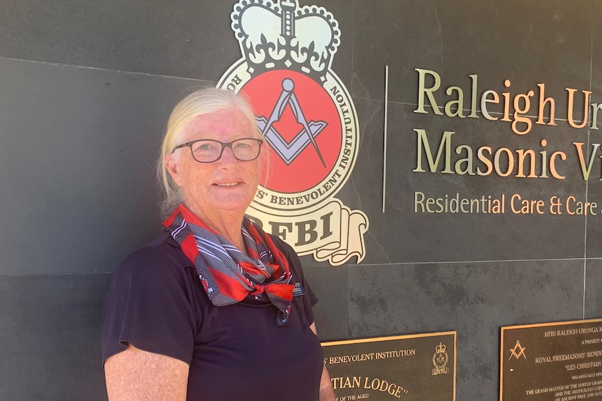 Elizabeth Diebold stands in front of the Raleigh Urunga Masonic Village entrance